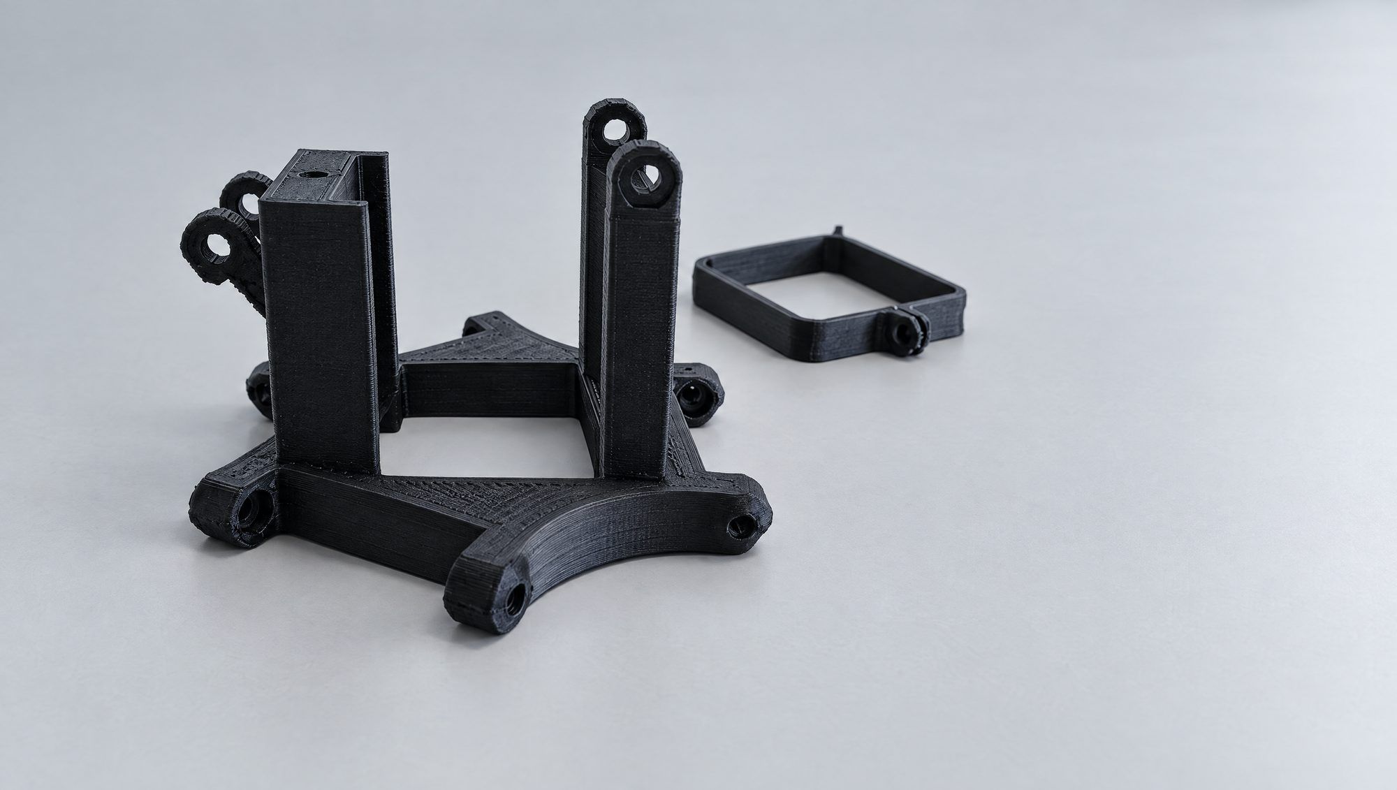 A black printed drone frame and parts